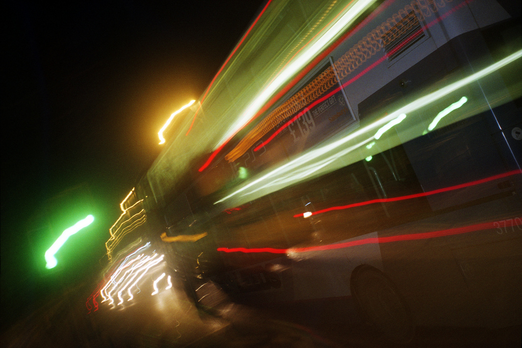 Image of light streaks from a bus passing at speed at night