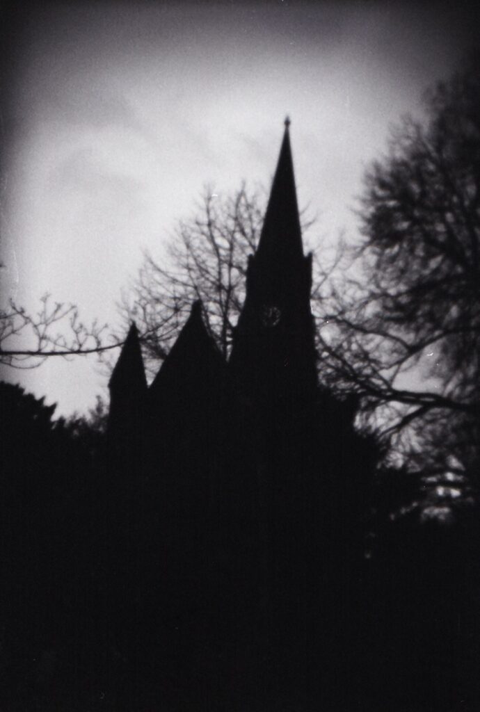 A black and shite photo of a silhouetted church
