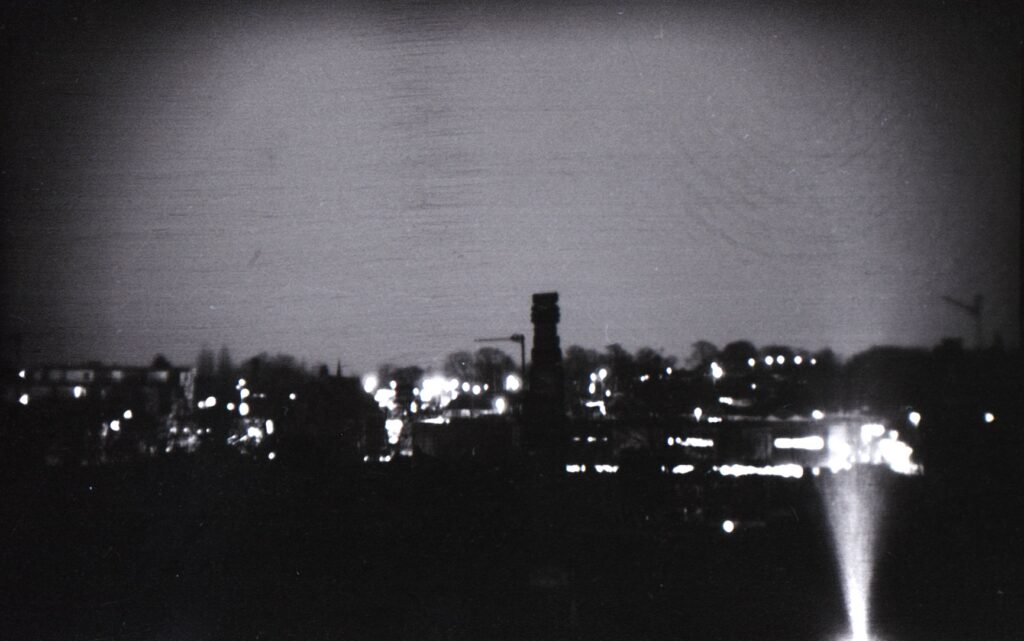 A black and white photo of a silhouetted skyline
