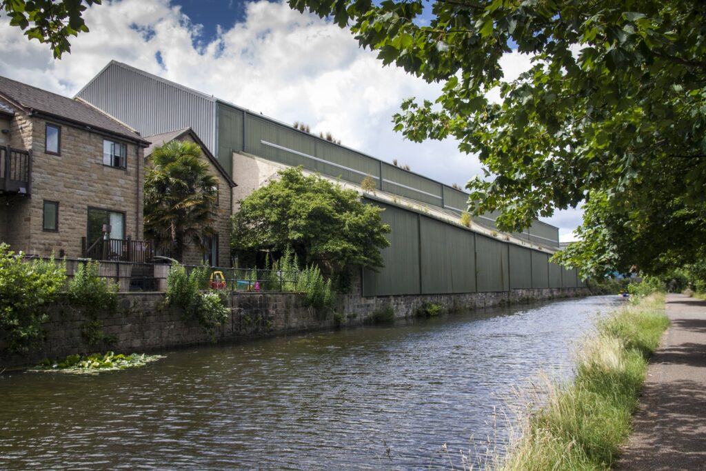 Corrugated steel building on the back of a canal